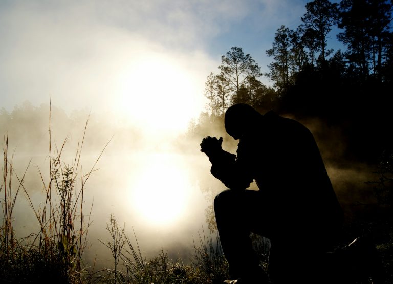 Silhouette man praying
