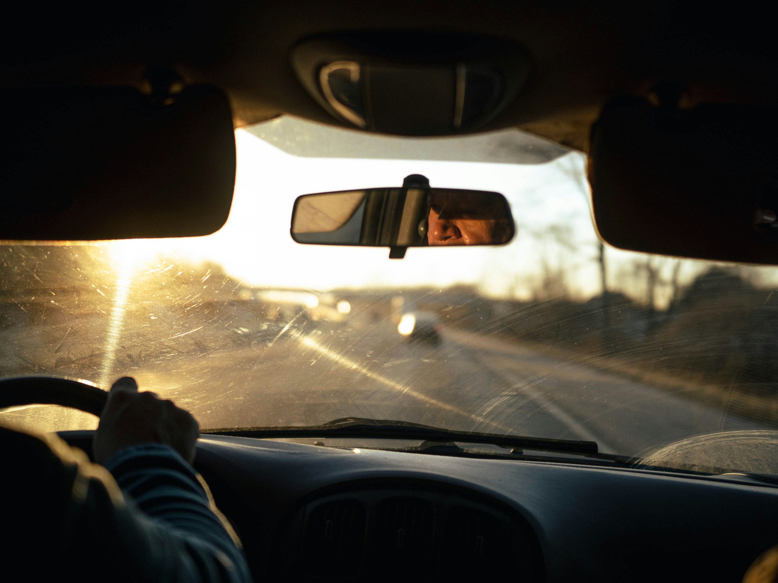 Steering wheel with morning sun by Joshua Fernandez
