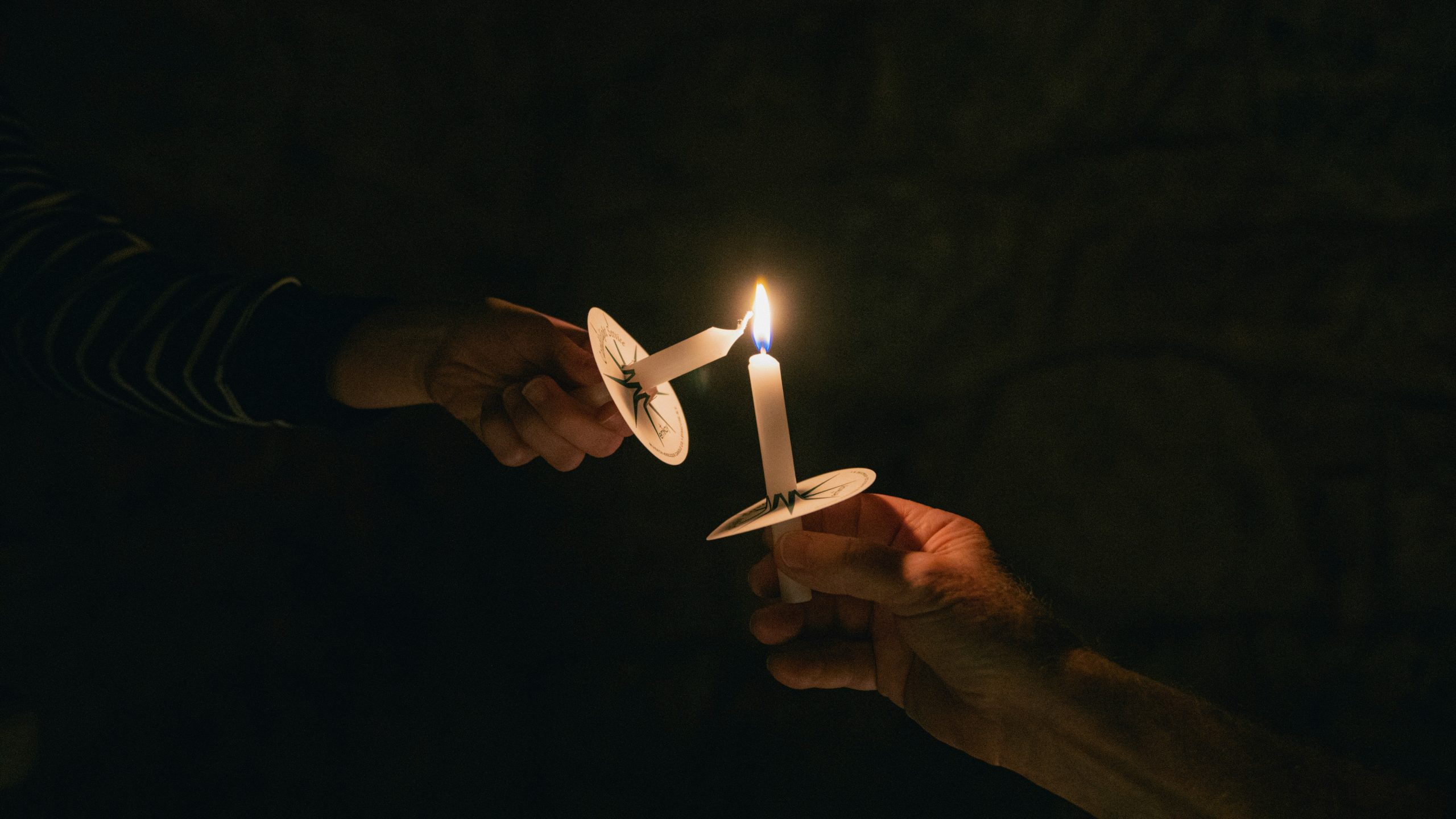 One candle lighting another by Zach Lucero